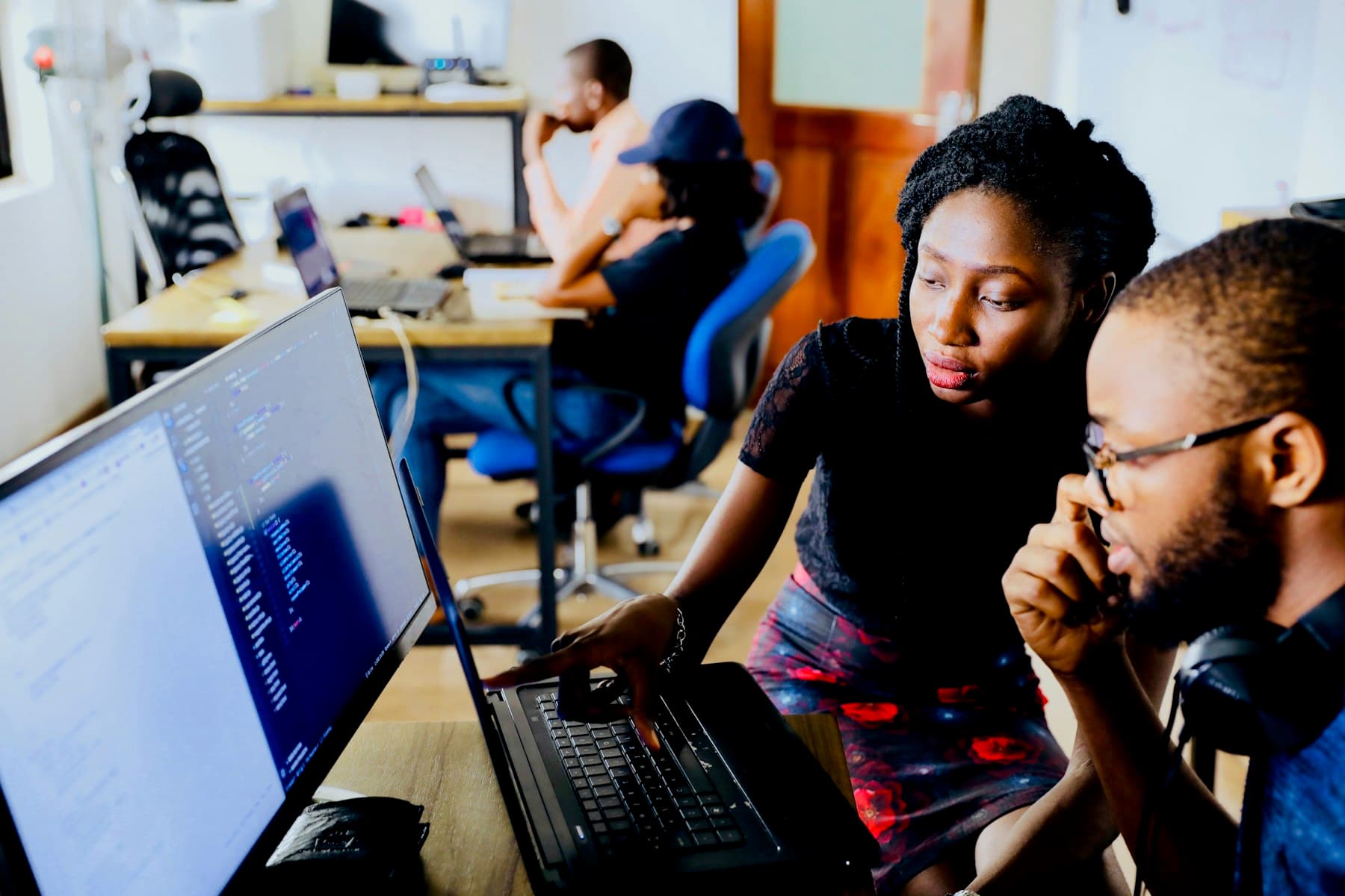 Two engineers reviewing code together at a workstation